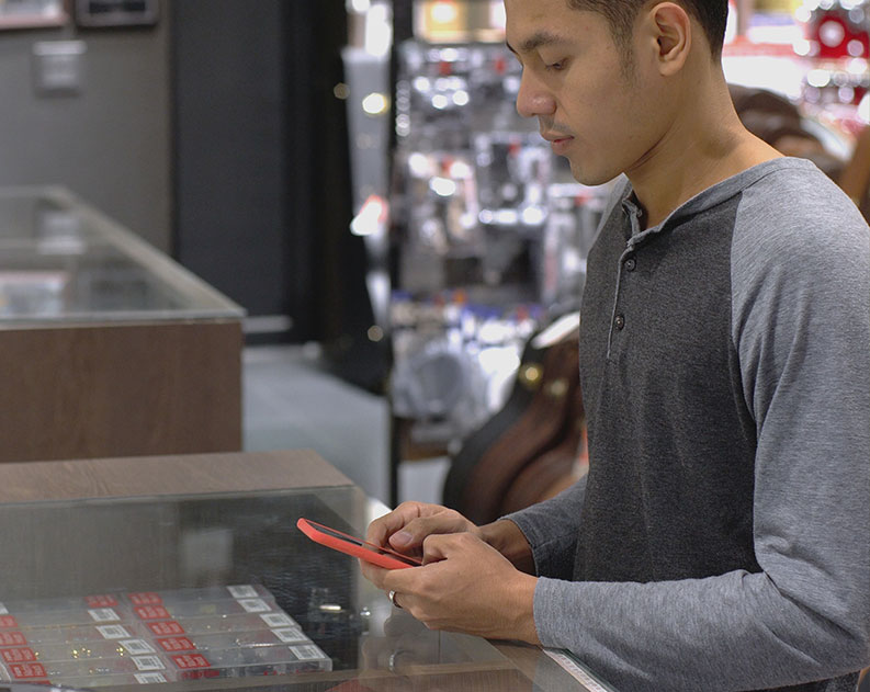 customer using phone at store counter